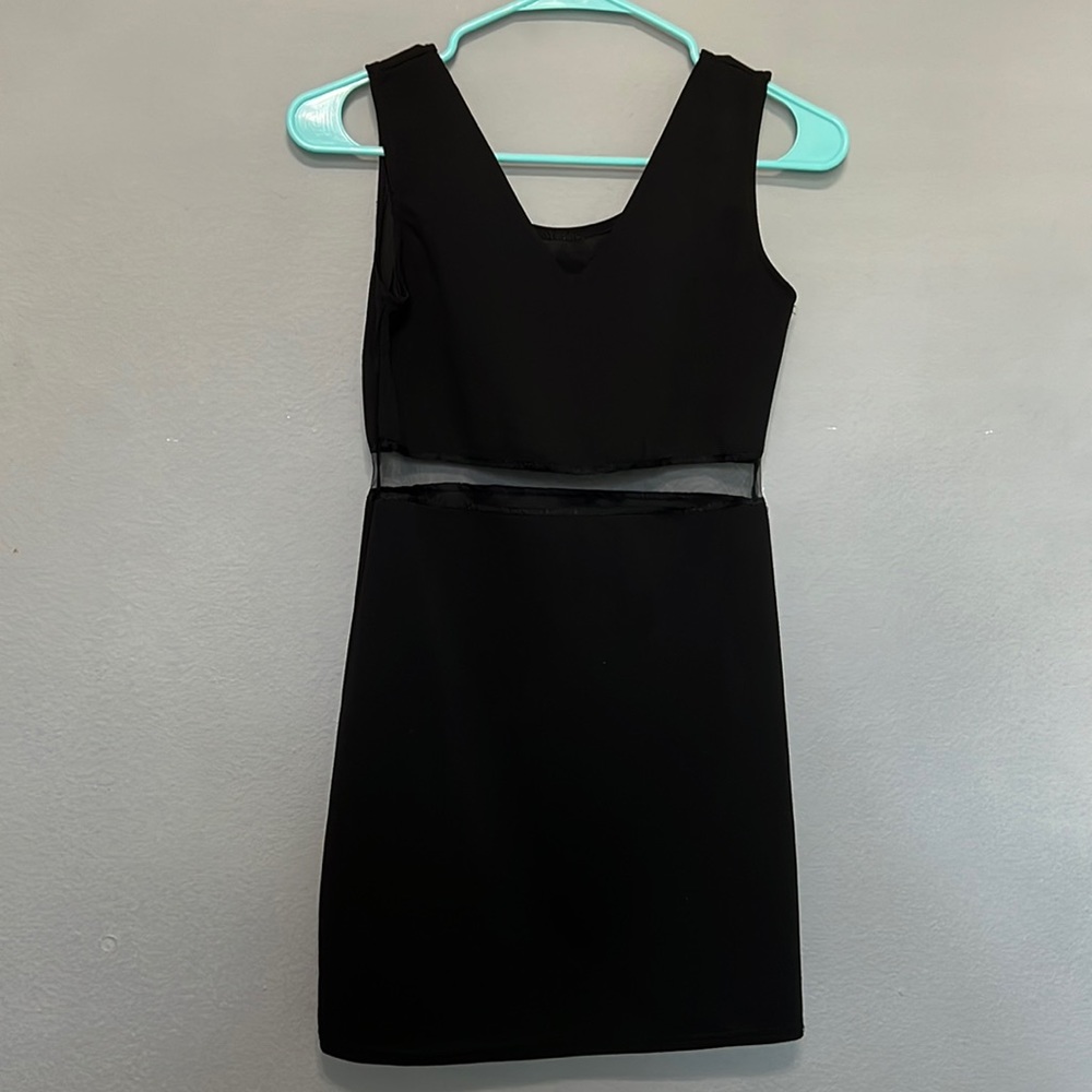 mini black dress with a V neck line and a sheer torso